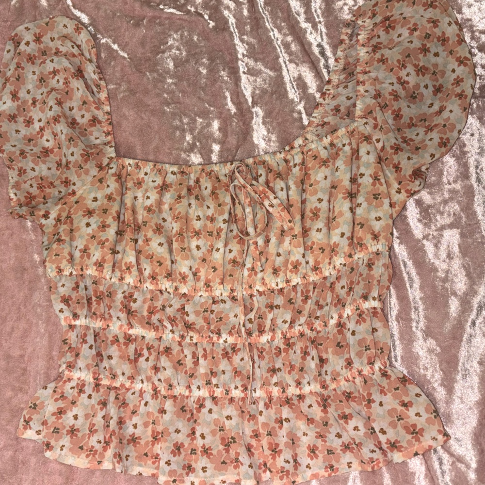 Orange flowered blouse. Mildly cropped